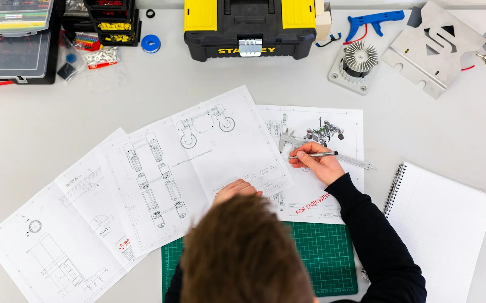 Laboratory technician working with precision equipment on a bench