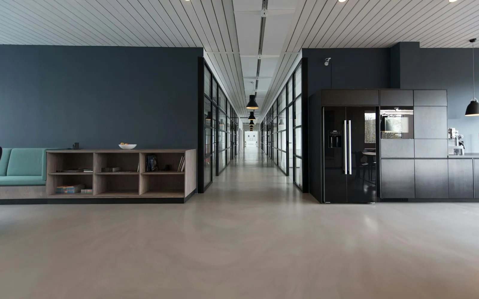 Modern office interior with glass meeting rooms and desks